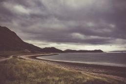 coastline-with-dark-clouds-with-mountains